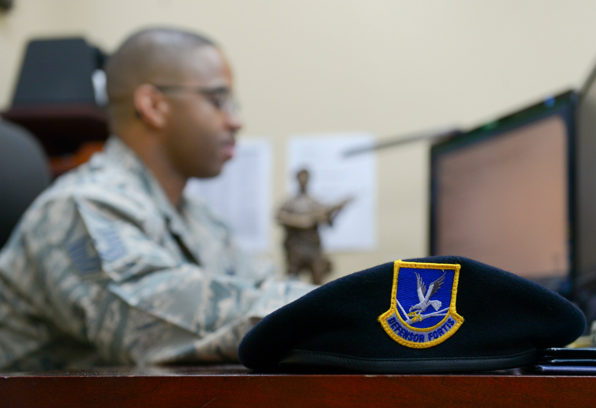 Master Sgt. Shamonte Saunders, 374th Security Forces Squadron superintendent of logistics and training, works at his desk at Yokota Air Base, April 20, 2016. Saunders attributes much of his resiliency to lessons his mother taught him and the example she lead by. (U.S. Air Force photo by Airman 1st Class Elizabeth Baker/Released)