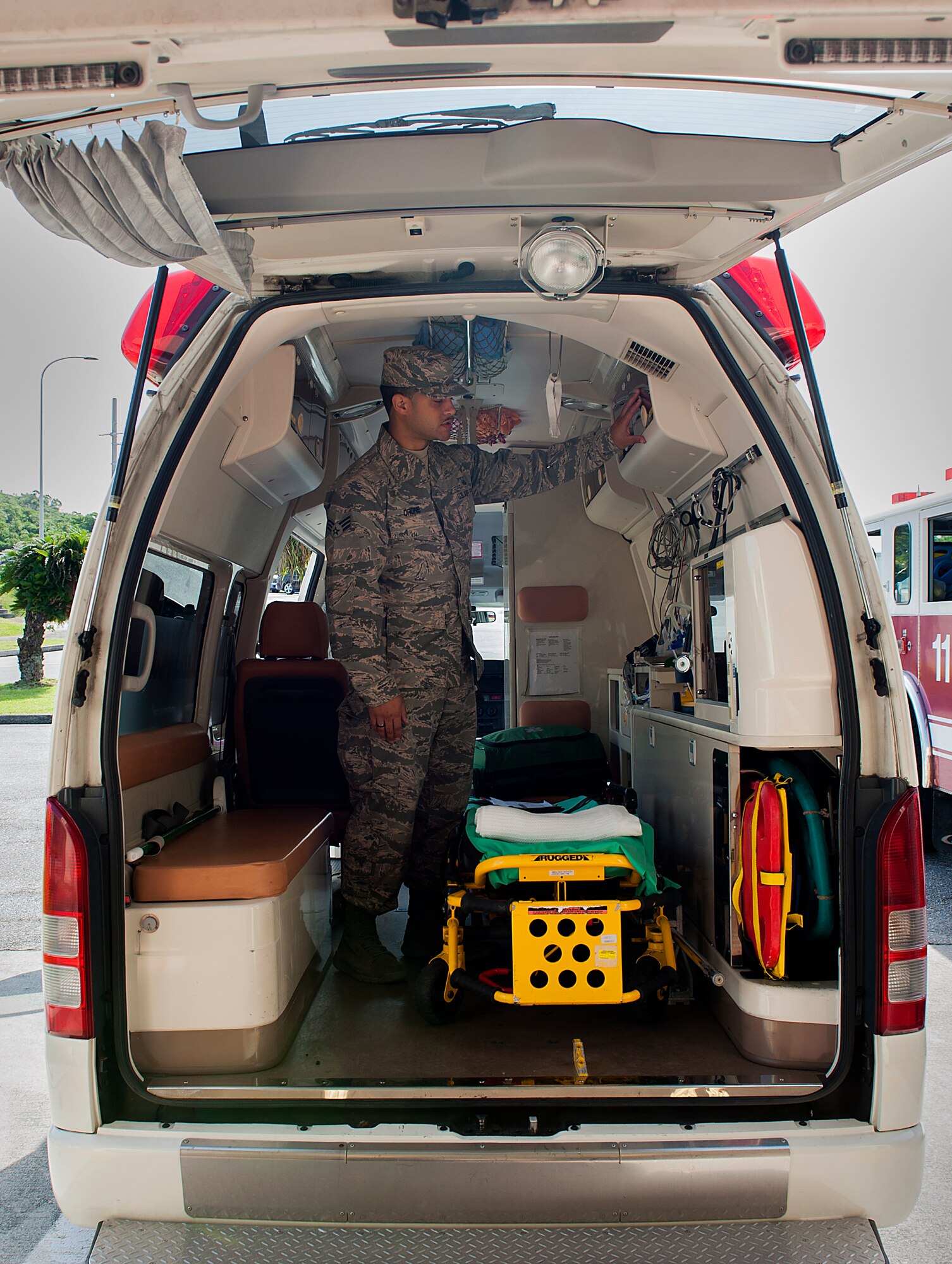 U.S. Air Force Senior Airman Kristoffer Drone, 18th Medical Operations Squadron emergency medical technician, looks through the back of an ambulance to make sure all the supplies are ready to go May 4, 2016, at Kadena Air Base, Japan. The Kadena Ambulance saves lives every day, running up to 700 emergency calls a year from Kadena to Maeda Point, Okinawa. (U.S. Air Force photo by Airman 1st Class Corey M. Pettis)