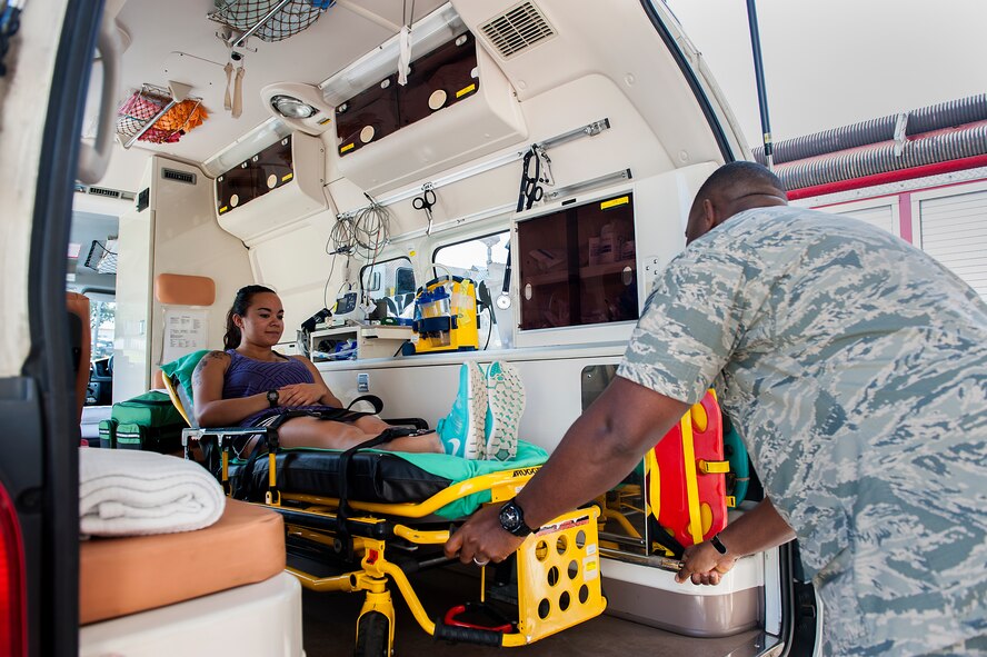 U.S. Air Force Tech. Sgt. Damian Sharpe, 18th Medical Operations Squadron NCO in charge of ambulance services, practices loading a patient into the back of an ambulance May 4, 2016, at Kadena Air Base, Japan. The Kadena Ambulance service is very busy responding to emergencies throughout the island, covering 50-60 calls a month. (U.S. Air Force photo by Airman 1st Class Corey M. Pettis)