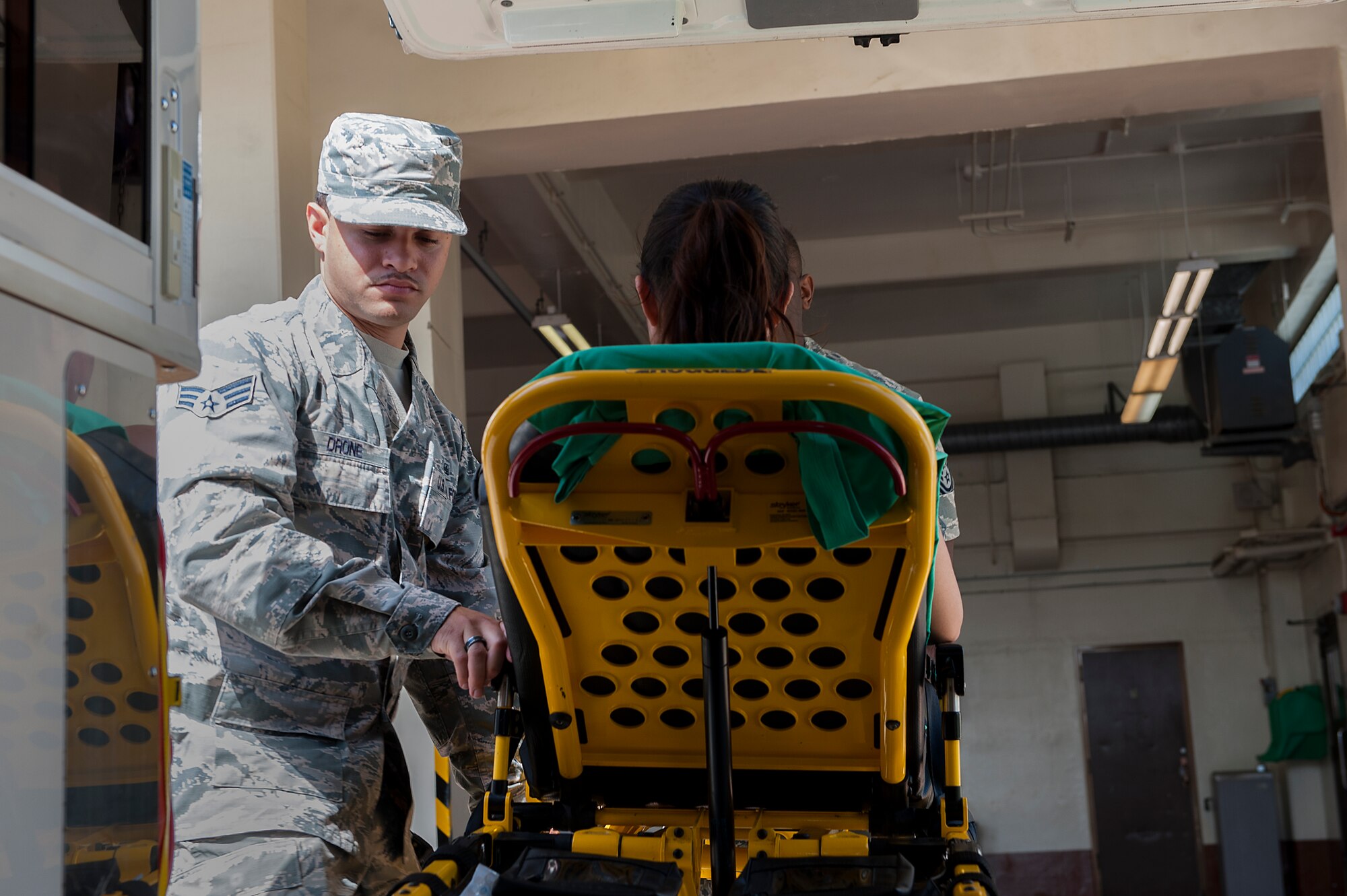 U.S. Air Force Senior Airman Kristoffer Drone, 18th Medical Operations Squadron emergency medical technician, practices loading a patient into the back of an ambulance May 4, 2016, at Kadena Air Base, Japan. The Kadena Ambulance service covers a radius of approximately 102 sq. kilometers. (U.S. Air Force photo by Airman 1st Class Corey M. Pettis)