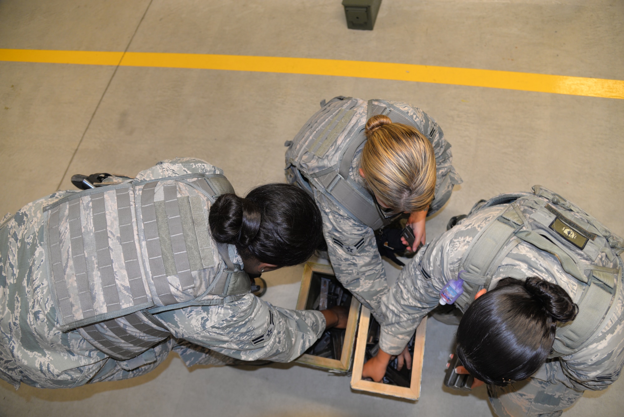 Airmen assigned to the 18th Security Forces Squadron get M9 pistol magazines during a combat arms training and maintenance course April 28, 2016, at Kadena Air Base, Japan. Defenders prepare for real-world deployments with mission-specific training and use the CATM range to ensure success. (U.S. Air Force photo by Staff Sgt. Benjamin Sutton) 