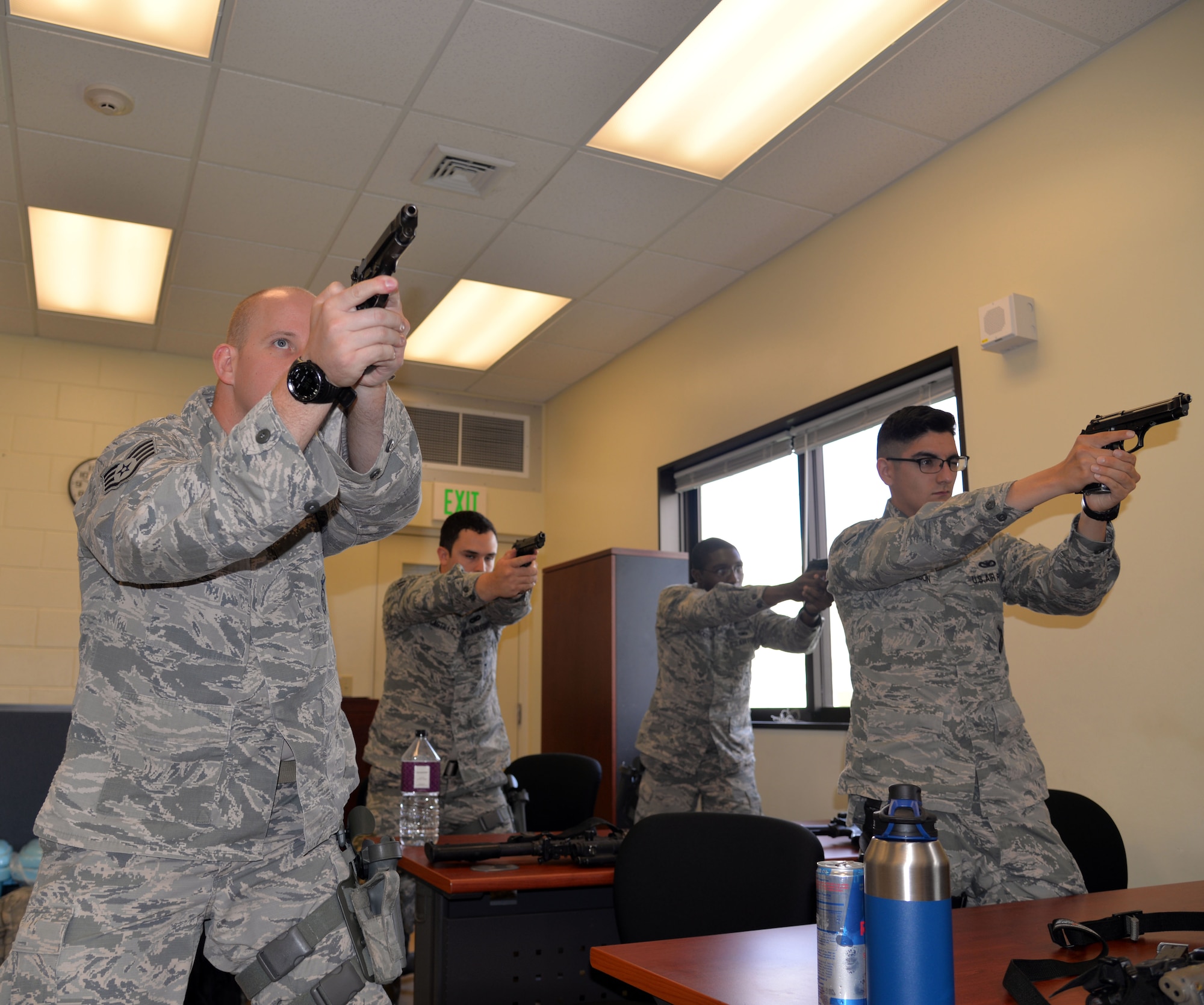 Airmen assigned to the 18th Security Forces Squadron practice quick firing and reloading procedures during a combat arms training and maintenance course April 28, 2016, at Kadena Air Base, Japan. Proper cooperation and training on the multiple weapons systems ensures Airmen are continually ready and qualified to complete missions daily. (U.S. Air Force photo by Staff Sgt. Benjamin Sutton) 