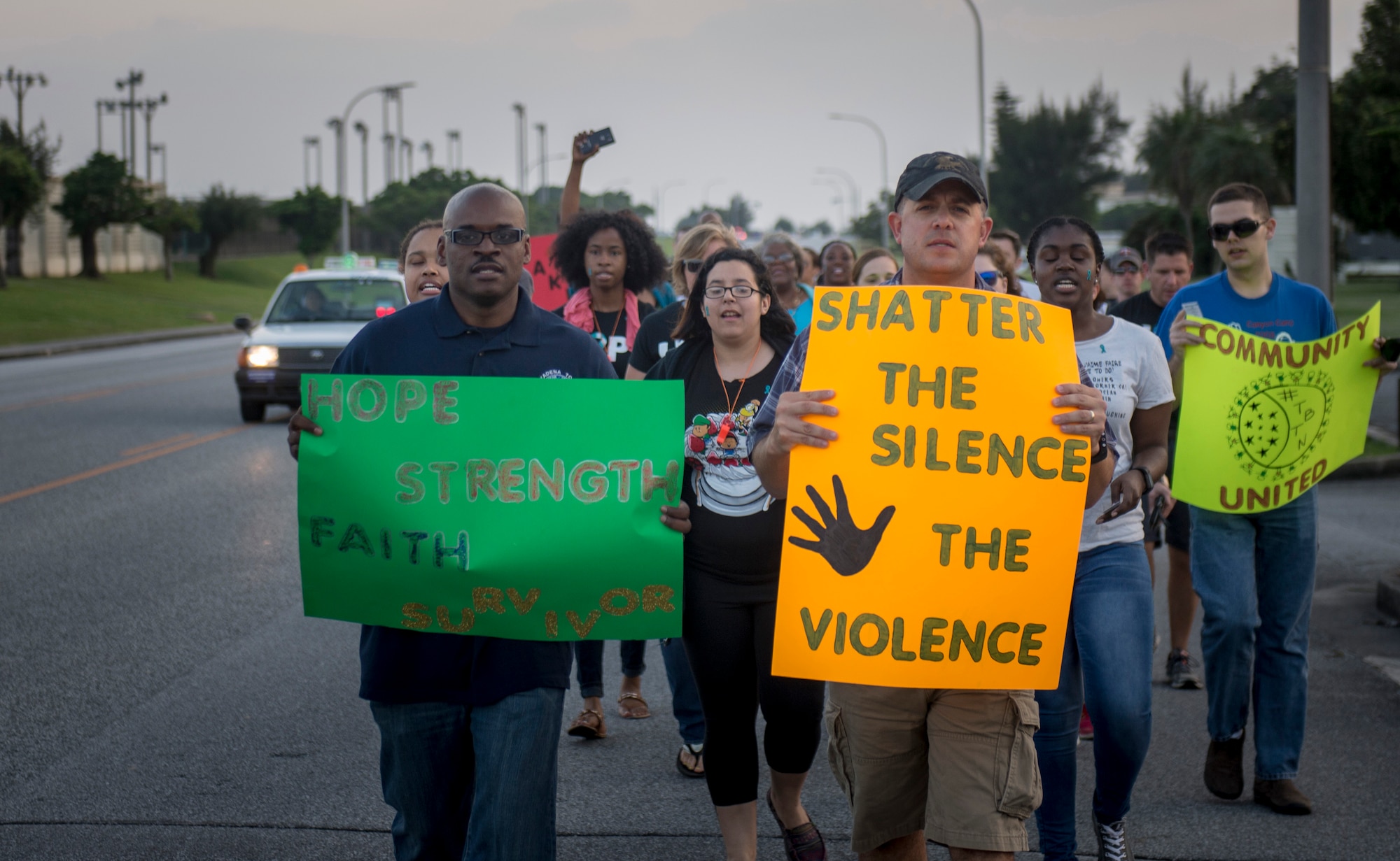 Women and men march shoulder-to-shoulder during the Take Back the Night April, 29, 2016, at Kadena Air Base, Japan. Kadena’s Take Back the Night is a rally, a march and a time to reflect. (U.S. Air Force photo by Senior Airman Omari Bernard) 