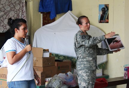 U.S. Army Staff Sgt. Lori Dameron, Joint Task Force-Bravo Medical Element, explains how to prevent the Zika, Dengue and Chikungunya viruses, and other illnesses common to the area, to a group of Guatemalans with the help of a translator from the Guatemalan Ministry of Health during a Medical Readiness Training Exercise at Jocotán, Chiquimula, Guatemala, April 29, 2016. After completing this initial health class, vitamins and de-worming medication are also provided for both children and adults.  (U.S. Army photo by Maria Pinel)