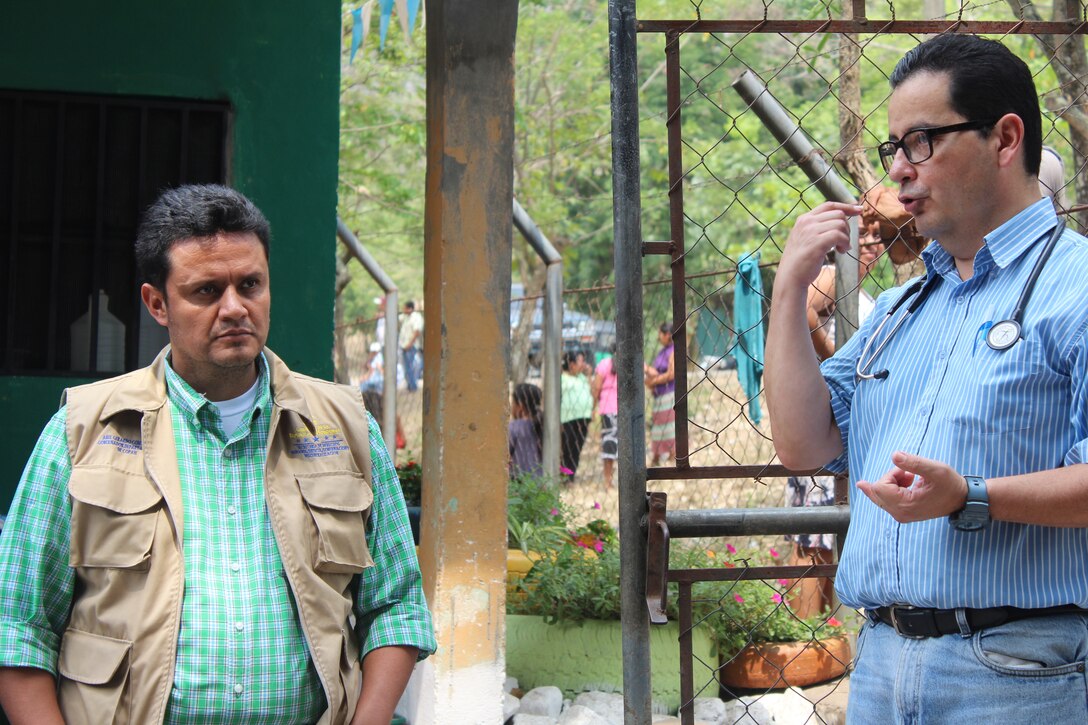 Dr. Carlos Durón (right), Joint Task Force-Bravo medical liaison explains the different services provided during a Medical Readiness Training Exercise to Mr. Abel Contreras, Governor of Copán, as part of a Civic Leader Engagement between regional key leaders, U.S. Embassy personnel and JTF-Bravo representatives in Ostumán, Copán, Honduras, April 28, 2016. These exercises allow service members to work side by side with their foreign counterparts and to develop a relationship between participating nations. (U.S. Army photo by Maria Pinel)