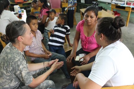 U.S. Army Capt. Yanna Ramaekers, Joint Task Force-Bravo Medical Element, listens to patients with the help of a volunteer translator during a Medical Readiness Training Exercise in Ostumán, Copán, Honduras, April 28, 2016. MEDRETES serve to validate a service member’s ability to provide care under austere conditions in remote locations, and also provide an opportunity for them to work side by side with foreign counterparts while providing much-needed medical care, developing partnerships and long-lasting relationships with other nations. (U.S. Army photo by Maria Pinel)