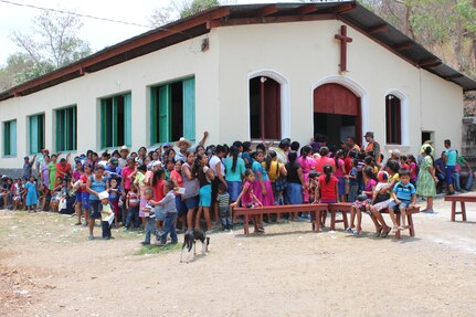 Guatemalan families wait outside a local church to receive a preventive health class during a Medical Readiness Training Exercise in Jocotán, Chiquimula, Guatemala, April 29, 2016. After concluding the initial class, patients receive soap, vitamins and de-worming medication, and then pass on to the screeners and medical providers.  (U.S. Army photo by Maria Pinel)