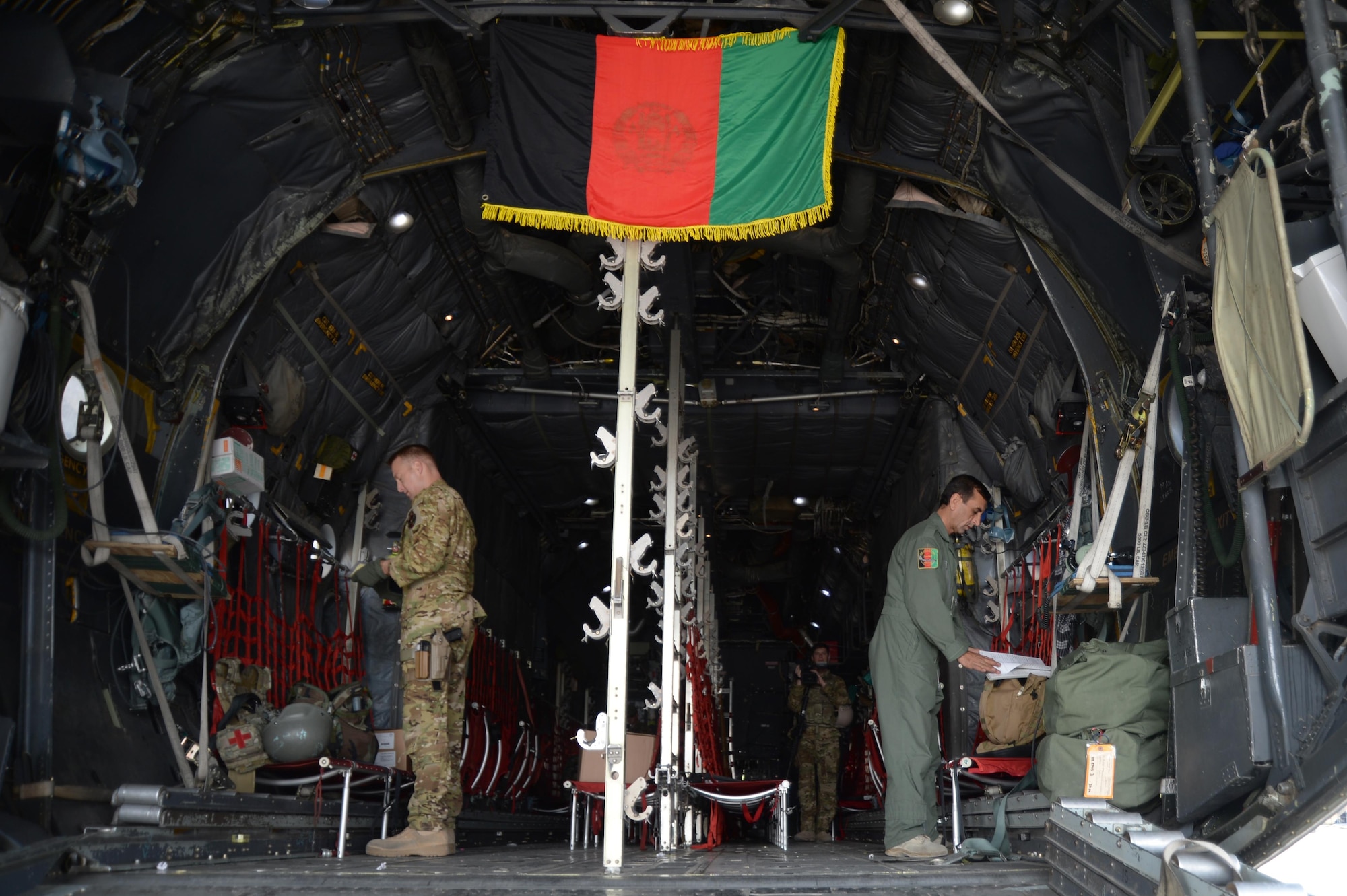U.S. advisors and Afghanistan Air Force students go through C-130H Hercules aircraft pre-flight checklists prior to a training flight in Kabul, Afghanistan, Sept. 22, 2015. Afghan air force students receive on-the-job training supervised by U.S. Air National Guard and Coalition advisors during real-world cargo and passenger sorties.(U.S. Air Force photo by Staff Sgt. Sandra Welch/released)