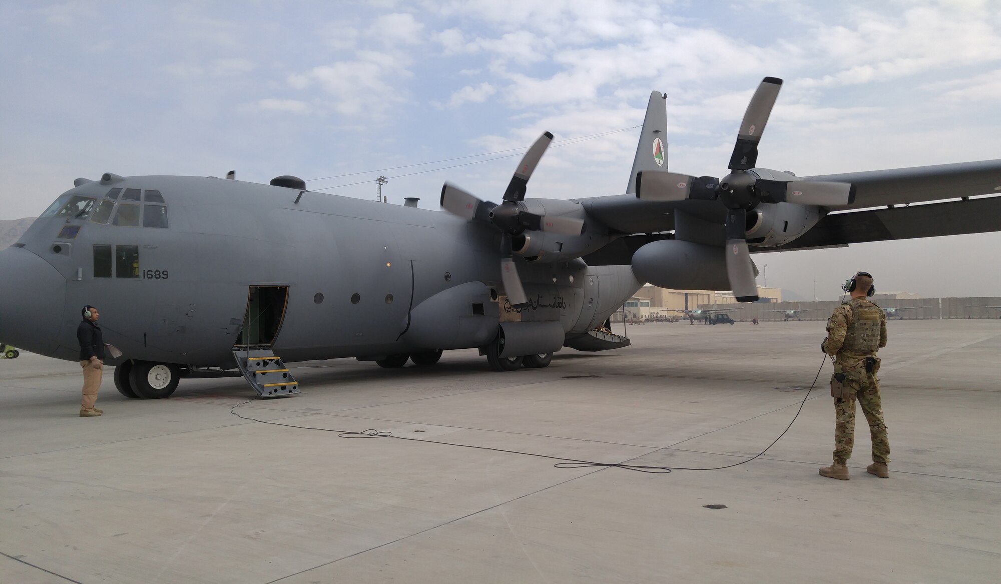 An Afghanistan Air Force loadmaster student observes a C-130H Hercules aircraft engine start on his “dollar ride where all aspects of the job are demonstrated to him for the first time, November 22, 2015. Afghan air force students receive on-the-job training supervised by U.S. Air National Guard and coalition instructors during real-world cargo and passenger sorties. (U.S. Air National Guard photo by Master Sgt. Christopher Coarse, 538th Air Expeditionary Wing/released)