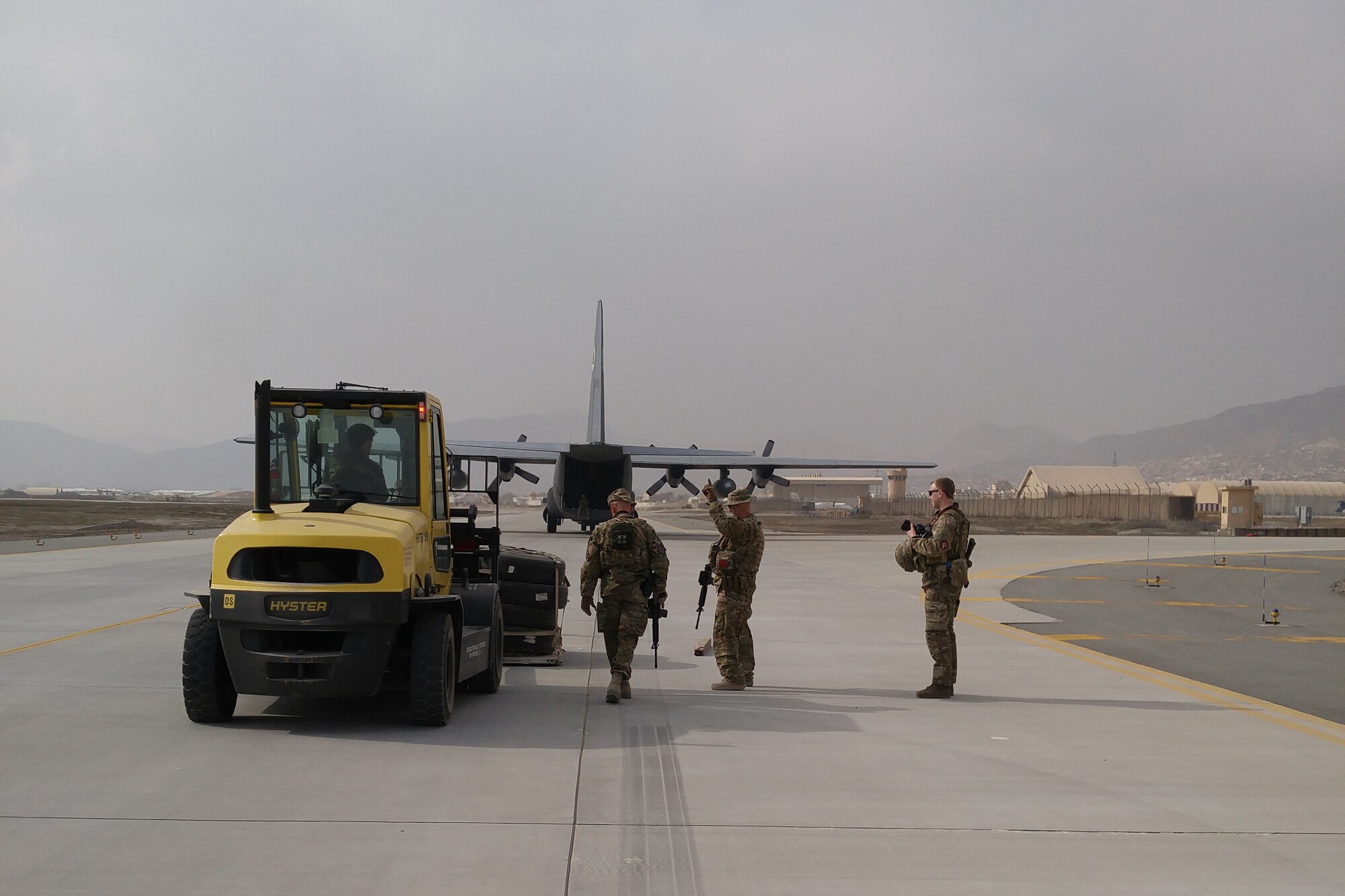 An Afghan forklift driver collects palletized cargo after U.S., Afghan and Turkish Airmen complete the first coalition training in C-130H Hercules aircraft combat offload for the Afghanistan Air Force, February 14, 2016. Afghan air force trainees receive on-the-job training supervised by U.S. Air National Guard and Coalition instructors during real-world cargo and passenger sorties. (U.S. Air National Guard photo by Master Sgt. Christopher Coarse, 538th Air Expeditionary Wing/released)