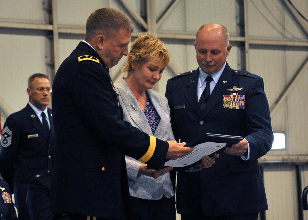 Maj. Gen. Timothy A. Reisch presents Dawn Jamison, wife of Brig. Gen. Matthew P. Jamison, Assistant Adjutant General for Air, HQ SDANG, a certificate of appreciation at a retirement ceremony held on May 1, 2016.  Jamison retires after 37 years with the South Dakota Air National Guard.(U.S. Air National Guard photo by Staff Sgt. Duane Duimstra/released