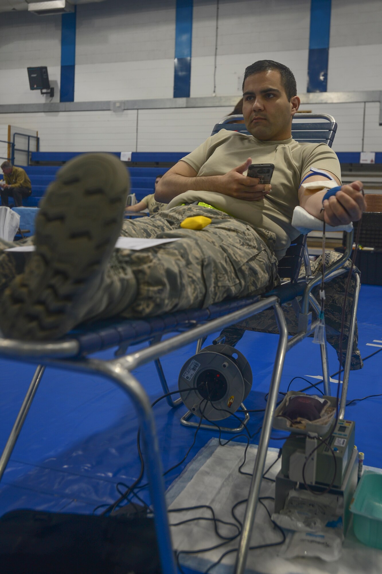 Airman 1st Class Ruben Gracia-Garcia, 48th Communications Squadron cyber systems operator, donates blood during the Armed Services Blood Program blood drive at Royal Air Force Lakenheath, England, May 3, 2016. Blood donated by military donors helps keep the need to purchase blood down as well as ensuring the integrity and safety of the blood supply. (U.S. Air Force photo by Senior Airman Dawn M. Weber/Released)