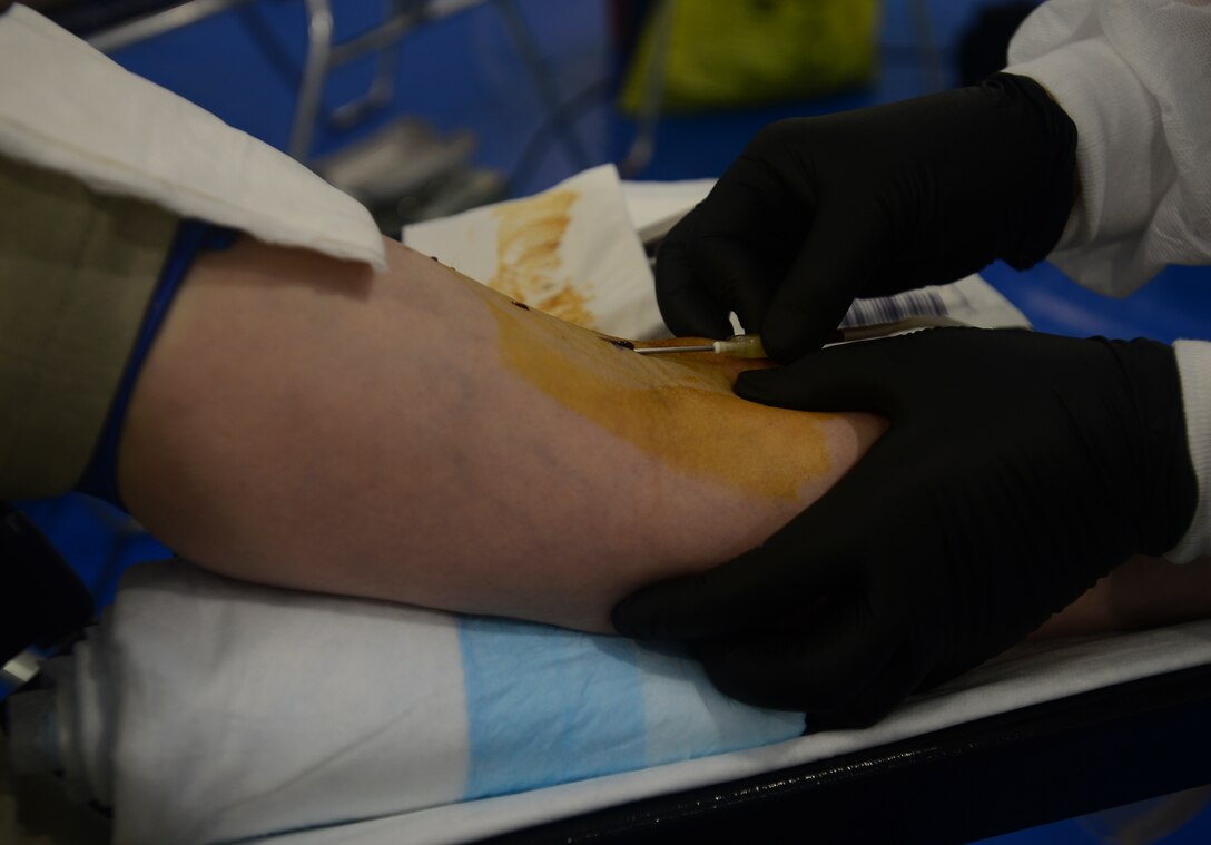 Blood is drawn from an Airman during the Armed Services Blood Program blood drive at Royal Air Force Lakenheath, England, May 3, 2016. The Military Blood program was established in 1952, and today the Armed Services Blood Program operates at 151 worldwide locations. (U.S. Air Force photo by Senior Airman Dawn M. Weber/Released)