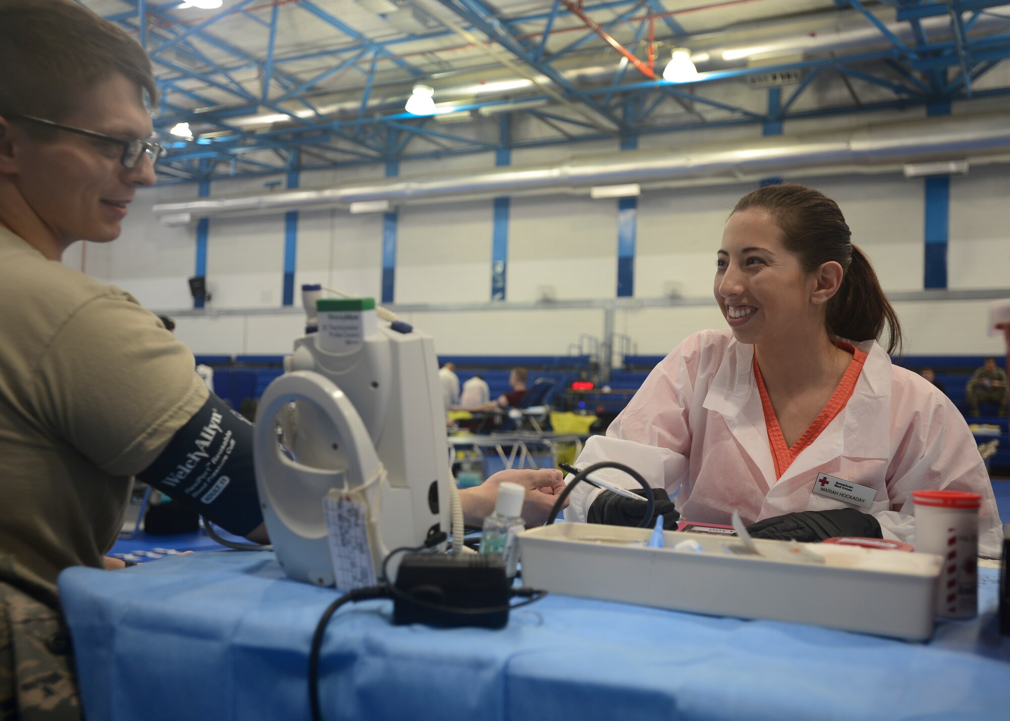 Mariah Hockaday, American Red Cross volunteer vitals technician, screens Airman 1st Class Edwin Keen, 48th Medial Support Squadron laboratory technician, before he donates blood at Royal Air Force Lakenheath, England, May 3, 2016. The Military Blood program was established in 1952, today the Armed Services Blood Program operates at 151 worldwide locations. (U.S. Air Force photo by Senior Airman Dawn M. Weber/Released)