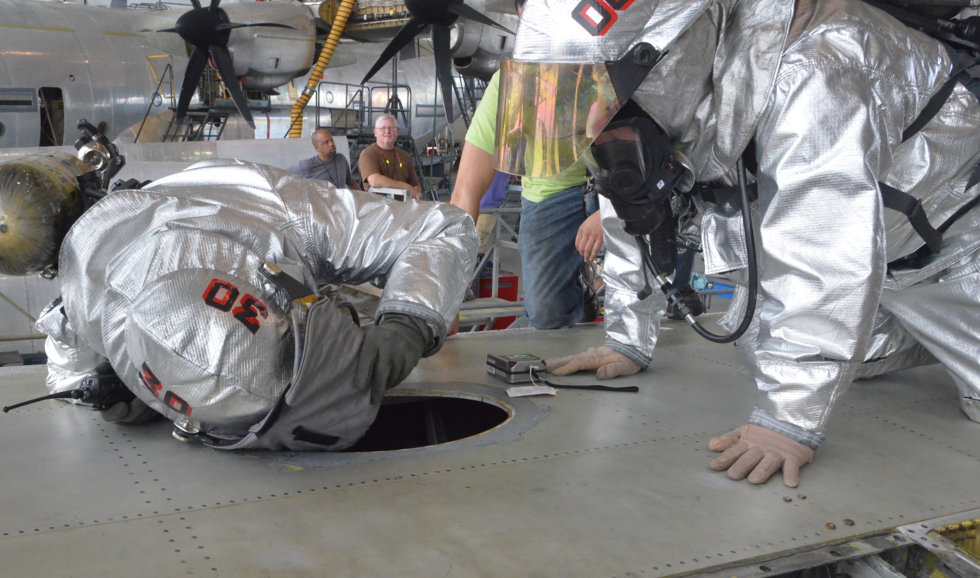 Robins Firefighter take part in confined space rescue training atop a C-130. (U.S. Air Force photo by Ray Crayton)