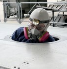 Jeremy Kahler, a 6-foot-2-inch aircraft electrician with the 560th Aircraft Maintenance quadron, works inside a confined space – a space that has limited or restricted means of entry or exit. (U.S. Air Force photo by Ray Crayton)