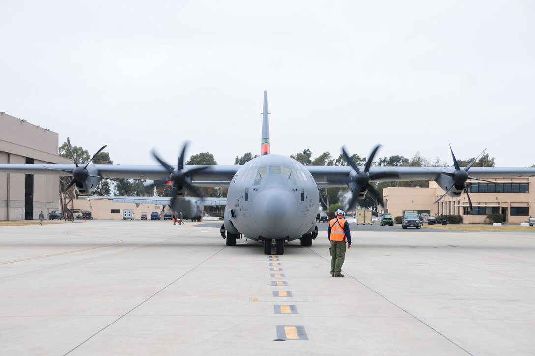 Assistant Tank Manager John Price from Gateway Tanker Base in Mesa, Arizona helps to direct a C-130 taxi out during MAFFS training at the 146th Airlift Wing in Port Hueneme, California on May 4, 2016. Air National Guard and Reserve units from across the U.S. convened for MAFFS (Modular Airborne Fire Fighting Systems)annual certification and training this week to prepare for the upcoming fire season in support of U.S. Forest Service. (U.S. Air National Guard photo by Senior Airman Madeleine Richards/Released)
