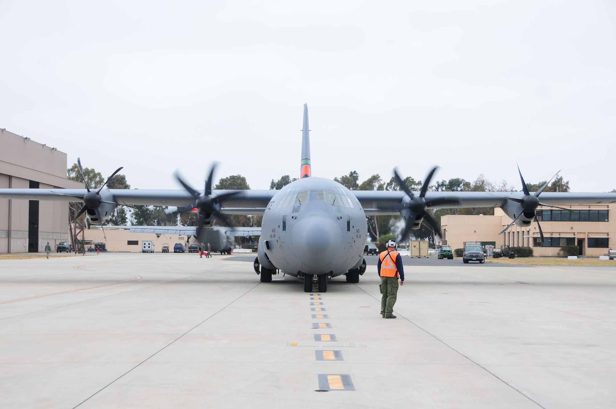 Assistant Tank Manager John Price from Gateway Tanker Base in Mesa, Arizona helps to direct a C-130 taxi out during MAFFS training at the 146th Airlift Wing in Port Hueneme, California on May 4, 2016. Air National Guard and Reserve units from across the U.S. convened for MAFFS (Modular Airborne Fire Fighting Systems)annual certification and training this week to prepare for the upcoming fire season in support of U.S. Forest Service. (U.S. Air National Guard photo by Senior Airman Madeleine Richards/Released)
