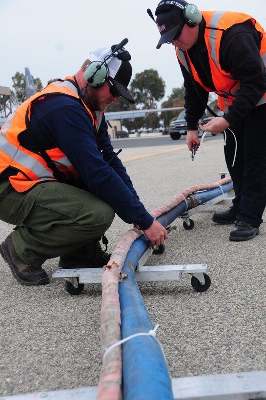 John Price, Assistant Tank Manager from Gateway Tanker Base in Mesa Arizona, and Tommy Bridge, Firefighter with CAL FIRE San Luis Obispo prepare to load a C-130 J MAFFS unit with water during training at the 146th Airlift Wing in Port Hueneme, California on May 4, 2016. Air National Guard and Reserve units from across the U.S. convened for MAFFS (Modular Airborne Fire Fighting Systems)annual certification and training this week to prepare for the upcoming fire season in support of U.S. Forest Service. (U.S. Air National Guard photo by Senior Airman Madeleine Richards/ Released)
