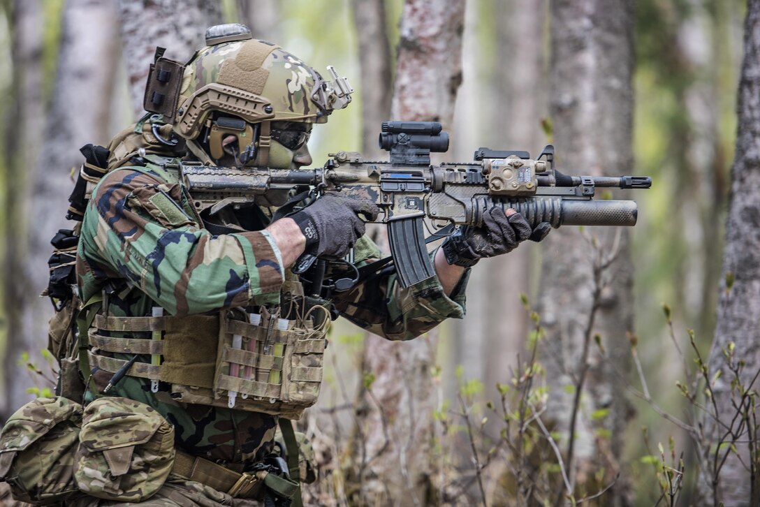 An airman participates in a mass-casualty training event at Joint Base Elmendorf-Richardson, Alaska, May 4, 2016. The exercise consisted of a tactical foot patrol in the woods on the joint base, where the rescue team members searched for reported casualties. The airman is assigned to the Alaska Air National Guard's 212th Rescue Squadron. Air National Guard photo by Staff Sgt. Edward Eagerton