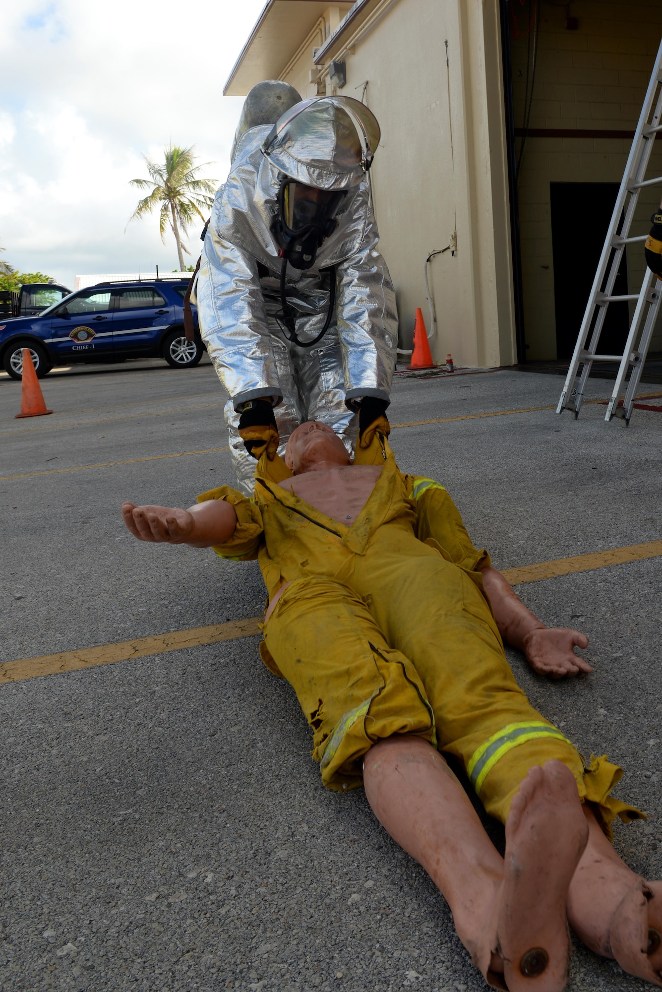 Airman 1st Class Kaleb Miranda, 36th Civil Engineer Squadron fire protection apprentice, drags a dummy across a parking lot during a firefighting obstacle course May 4, 2016, at Andersen Air Force Base, Guam. An obstacle course tested Airmen’s ability to run with firehoses, personnel rescue and climbing up and down a ladder while wearing personal protective equipment and a self-contained breathing apparatus. (U.S. Air Force photo by Airman 1st Class Alexa Ann Henderson)