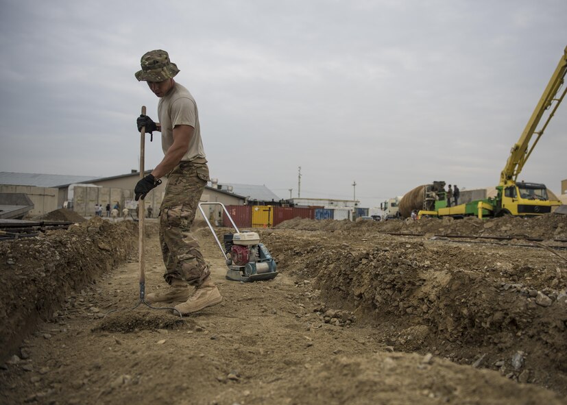 Staff Sgt. Casey Epps, 455th Expeditionary Civil Engineer Squadron Dirt Boy, levels out dirt for the placement of a footer at Bagram Airfield, Afghanistan, May 03, 2016. These professionals are part of a team that does everything from operating heavy construction equipment to laying down foundations in order to care for and create facilities across Bagram airfield. (U.S. Air Force photo by Senior Airman Justyn M. Freeman)