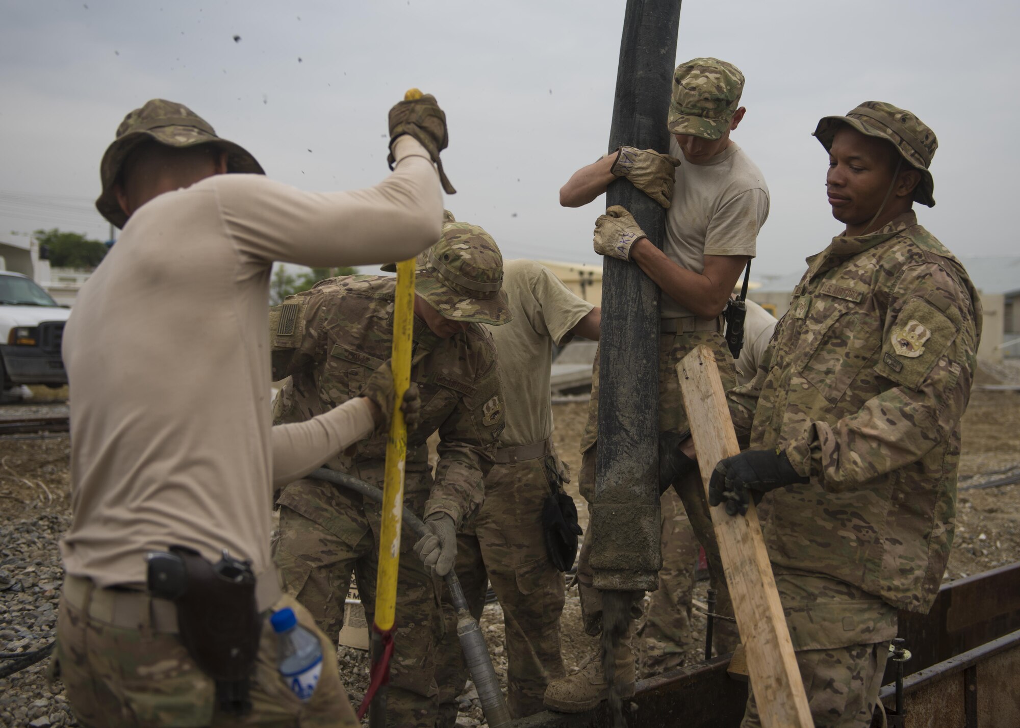 Members of the 455th Expeditionary Civil Engineer Squadron pour concrete into a cement footer at Bagram Airfield, Afghanistan, May 03, 2016. These professionals are part of a team that does everything from operating heavy construction equipment to laying down foundations in order to care for and create facilities across Bagram Airfield. (U.S. Air Force photo by Senior Airman Justyn M. Freeman)
