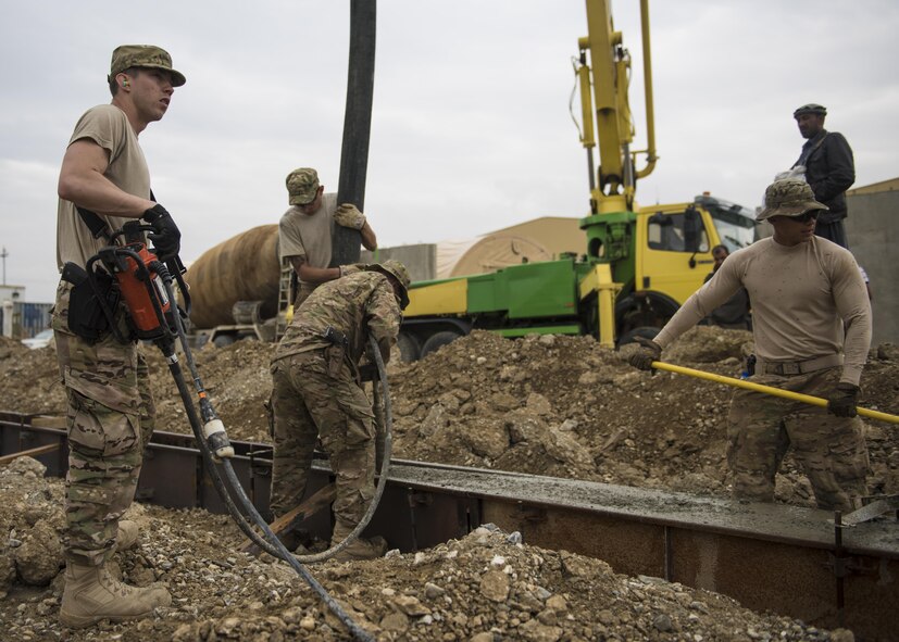 Members of the 455th Expeditionary Civil Engineer Squadron pour, distribute, release trapped air bubbles, and smooth out concrete at Bagram Airfield, Afghanistan, May 03, 2016. Civil Engineer personnel can construct runways and airfields in remote global locations in addition to maintaining facilities already in use. (U.S. Air Force photo by Senior Airman Justyn M. Freeman)