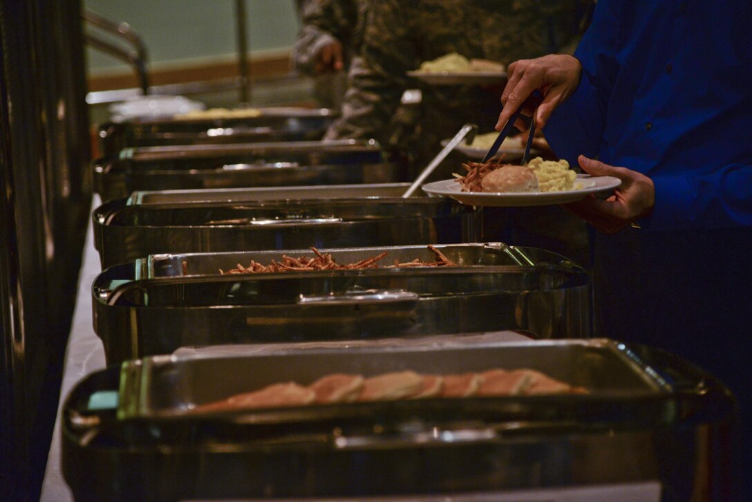 Attendees grab breakfast food during the Osan Holocaust Remembrance Breakfast event May 2, 2016, at the Osan Enlisted Club. The Breakfast featured a Jewish military chaplain who gave a speech on the the importance of keeping faith. (U.S. Air Force photo by Tech. Sgt. Travis Edwards/Released)