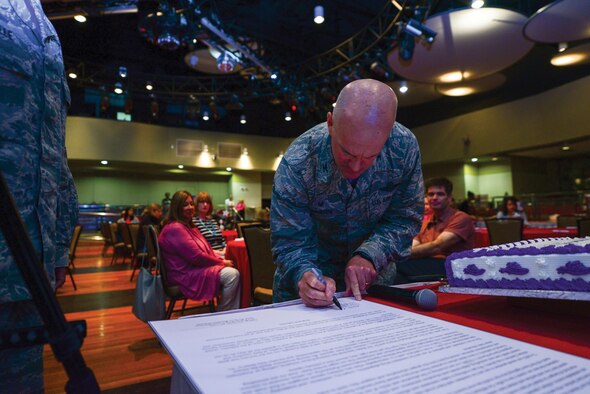 Col. Andrew Hansen, 51st Fighter Wing commander, signs Spouse Appreciation Day proclamation, May 6, 2016, at Osan Air Base, Republic of Korea. The Airman and Family Readiness Center hosted a free lunch and provided spouses with tokens of appreciation from agencies around base in recognition of their contributions to mission success.  (U.S. Air Force photo by Senior Airman Victor J. Caputo/Released)