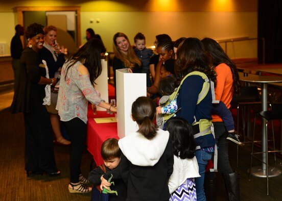 Team Osan spouses and children line up around information booths during Spouse Appreciation Day, May 6, 2016, at Osan Air Base, Republic of Korea. The Airman and Family Readiness Center hosted a free lunch and provided spouses with tokens of appreciation from agencies around base in recognition of their contributions to mission success. (U.S. Air Force photo by Senior Airman Victor J. Caputo/Released)