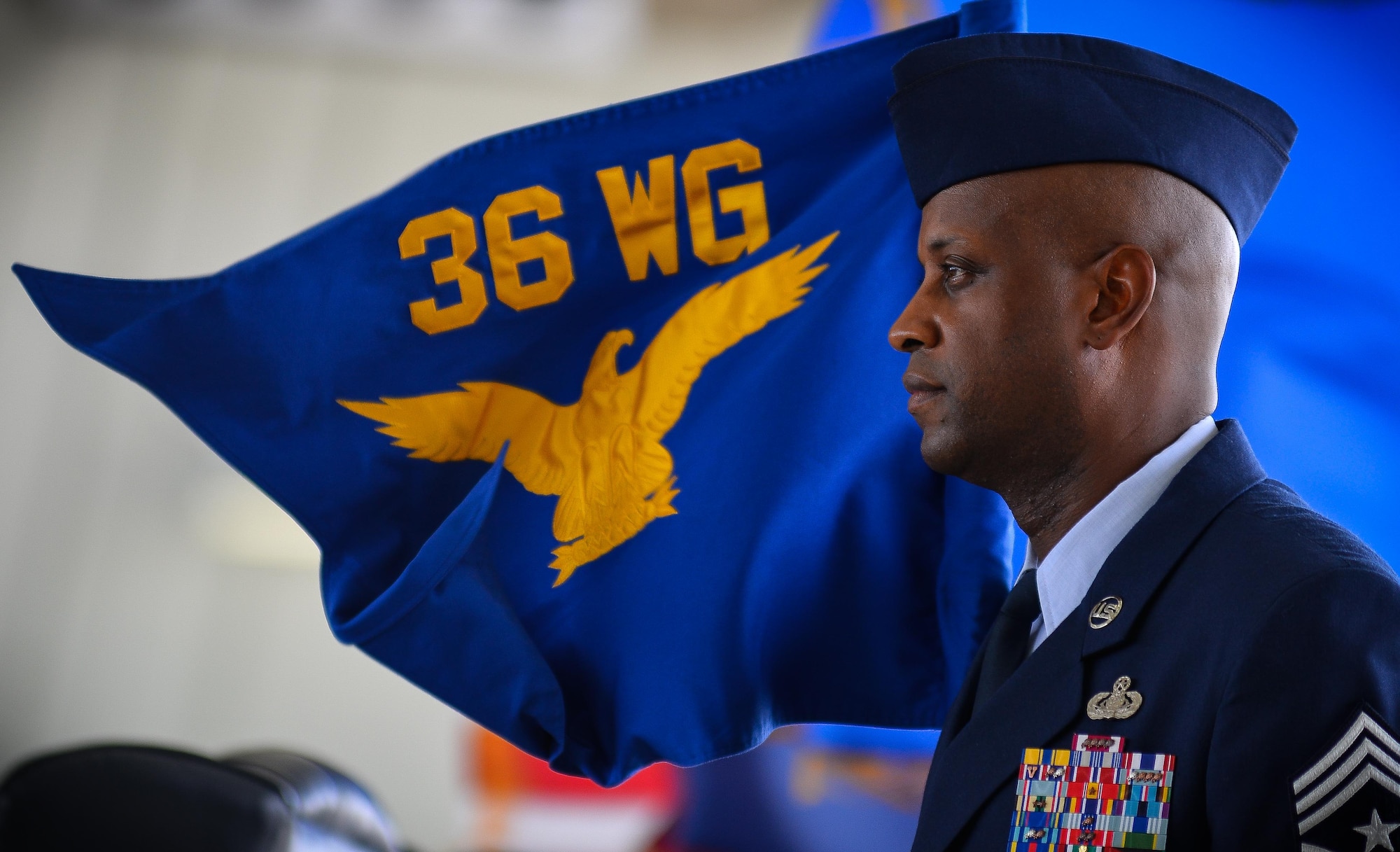 Chief Master Sgt. Michael McMillan, 36th Wing command chief, stands with the wing guidon during a change in command ceremony May 6, 2016, at Andersen AIr Force Base, Guam. The ceremony marked the transfer of command from Brig. Gen. Andrew Toth to Brig. Gen. Douglas Cox. (U.S. Air Force photo by Staff Sgt. Alexander W. Riedel)