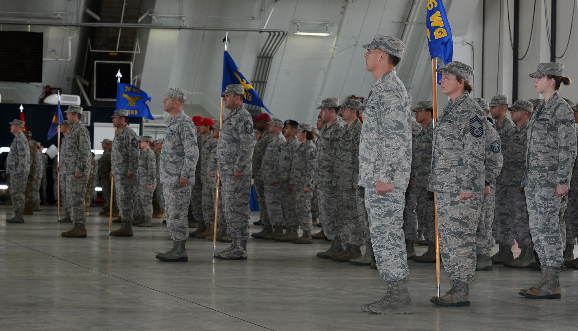 Airmen and Soldiers assigned to Andersen Air Force Base stand in formation during the 36th Wing change of command ceremony May 6, 2016, at Andersen AFB, Guam. A change of command is a military tradition that represents a formal transfer of authority and responsibility for a unit from one commanding or flag officer to another. (U.S. Air Force photo by Airman 1st Class Arielle Vasquez/Released) 