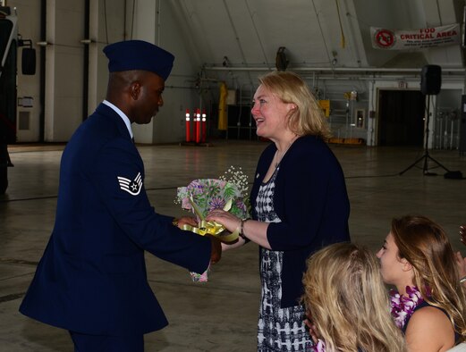 Lynae Cox, spouse of the 36th Wing commander, Brig. Gen. Douglas Cox, receives flowers during the wing change of command ceremony May 6, 2016, at Andersen Air Force Base, Guam. During the change of command, Cox assumed command of the 36th Wing. (U.S. Air Force photo by Senior Airman Joshua Smoot)