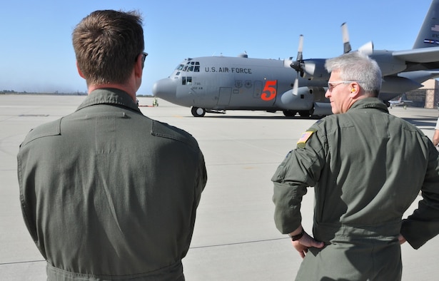 Col. Erich Novak (right), 302nd Airlift Wing vice commander, looks on as a 302nd AW C-130H3 Hercules and its Air Force Reserve crew prepare to taxi for take off as the flying portion of the 2016 Modular Airborne Fire Fighting System certification week begins in Ventura, Calif., May 3, 2016. The annual certification week, taking place May 2-6, brings together members of the Air National Guard and Air Force Reserve to be certified on operating MAFFS in the event of being called upon to support wildland fire containment. The wings include North Carolina's 145th AW; California's 146th AW; Wyoming's 153rd AW; and the AF Reserve's 302nd AW. (U.S. Air Force photo/2nd Lt. Stephen J. Collier)