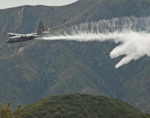 A line of water is dropped high above Angeles National Forest in Southern California from an Air National Guard C-130 Hercules on May 3, 2016, during a training mission. The C-130 was equipped with the Modular Airborne Firefighting System, used to combat wildfires. (U.S. Air National Guard photo/Staff Sgt. Nicholas Carzis)