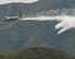 A line of water is dropped high above the Los Angeles Forest from a Air National Guard C-130 containing the MAFFS (Modular Airborne Firefighting System) system used to combat wild fires during annual MAFFS training on May 3 2016. (U.S. Air National Guard photo by Staff Sgt. Nicholas Carzis)