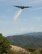 A line of water is dropped high above the Los Angeles Forest from a Air National Guard C-130 containing the MAFFS (Modular Airborne Firefighting System) system used to combat wild fires during annual MAFFS training on May 3 2016. (U.S. Air National Guard photo by Staff Sgt. Nicholas Carzis)