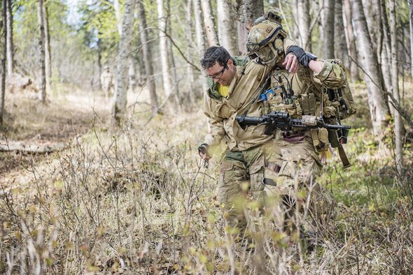 Members of the Alaska Air National Guard’s 212th Rescue Squadron participate in a mass casualty training event on Joint Base Elmendorf-Richardson, Alaska, May 4, 2016. The exercise consisted of a tactical foot patrol in the woods, where rescue team members reported casualties. During the movement, the team was ambushed by opposition forces, causing them to react to contact, suppress enemy fire, and call for close air support. This training prepares the Air Force's elite rescue personnel for the types of high-risk rescue missions they conduct when deployed in defense of their nation. (U.S. Air National Guard photo/Staff Sgt. Edward Eagerton)