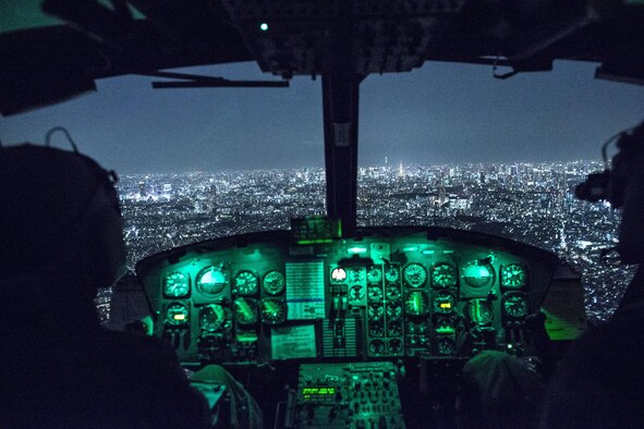 Capt. Jonathan Bonilla and 1st Lt. Vicente Vasquez, 459th Airlift Squadron UH-1N Huey pilots, fly over Tokyo after completing night training April 25, 2016. The 459th AS frequently trains on a multitude of scenarios in preparation for potential real-world contingencies and operations. (U.S. Air Force photo/Yasuo Osakabe)
