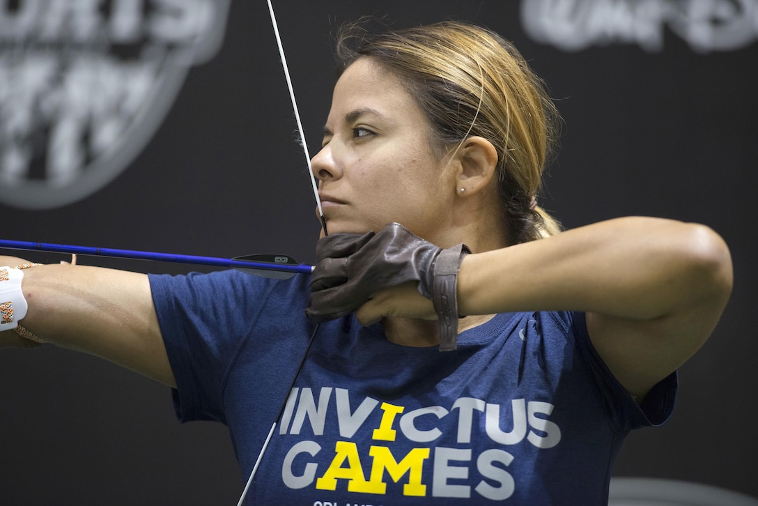 Air Force Staff Sgt. Ana Lopez-Arellano takes aim while practicing archery for the 2016 Invictus Games in Orlando, Fla., May 5, 2016. DoD photo by Roger Wollenberg