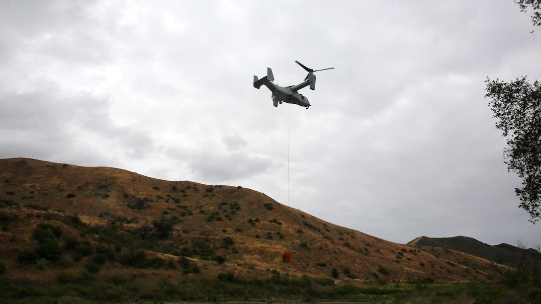 An aircraft flys over Las Pulgas Lake in California during Wildland Firefighting Exercise 2016 hosted by Marine Corps Base Camp Pendleton, May 5. The Wildland Firefighting Exercise 2016 combines elements of aviation and ground units from Marine Corps Base Camp Pendleton, 3rd Marine Air Wing, Navy Region Southwest, The California Department of Forestry and Fire Protection, and the San Diego's Sheriff's Department.