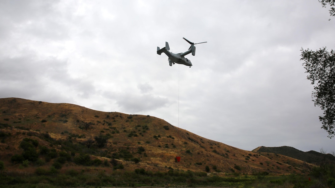 An aircraft flys over Las Pulgas Lake in California during Wildland Firefighting Exercise 2016 hosted by Marine Corps Base Camp Pendleton, May 5. The Wildland Firefighting Exercise 2016 combines elements of aviation and ground units from Marine Corps Base Camp Pendleton, 3rd Marine Air Wing, Navy Region Southwest, The California Department of Forestry and Fire Protection, and the San Diego's Sheriff's Department.