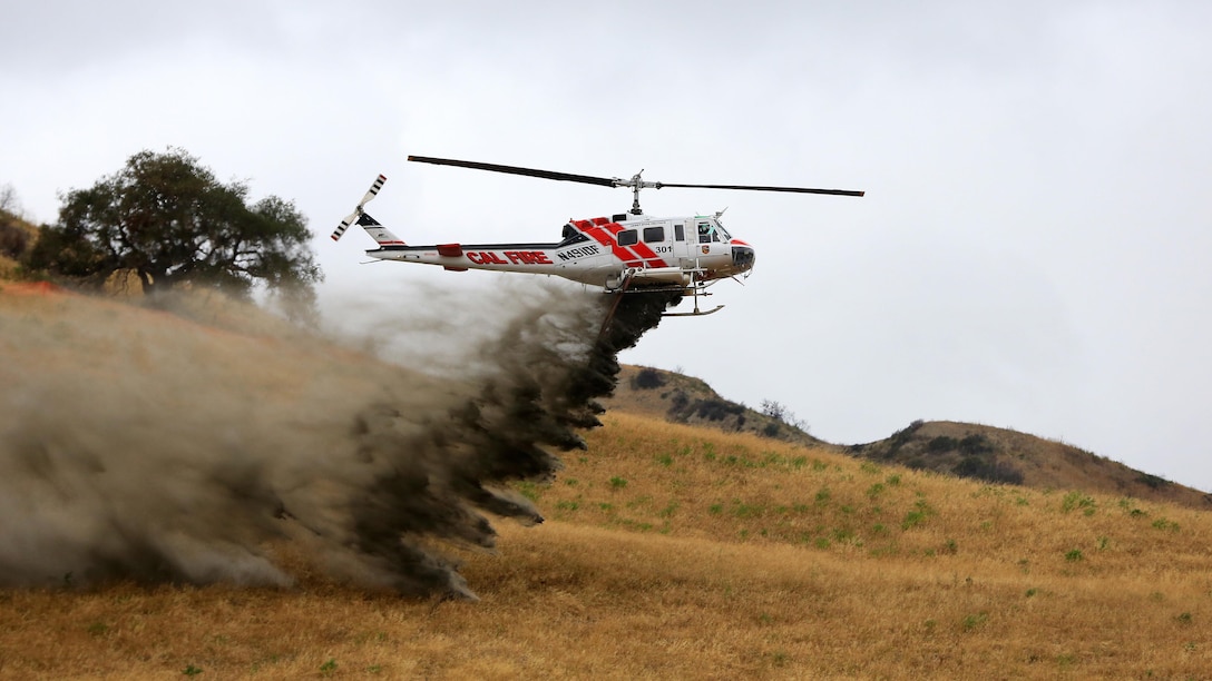 An aircraft flys near Las Pulgas Lake, California during Wildland Firefighting Exercise 2016 hosted by Marine Corps Base Camp Pendleton, California, May 5. The Wildland Firefighting Exercise 2016 combines elements of aviation and ground units from Camp Pendleton, 3rd Marine Air Wing, Navy Region Southwest, The California Department of Forestry and Fire Protection, and the San Diego's Sheriff's Department