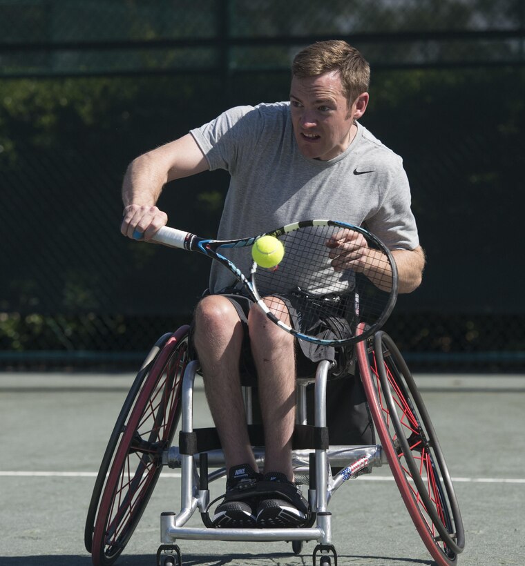 Retired Navy Seaman Austin Field returns a shot while training in the wheelchair tennis event at the 2016 Invictus Games in Orlando, Fla., May 5, 2016. DoD photo by Roger Wollenberg
