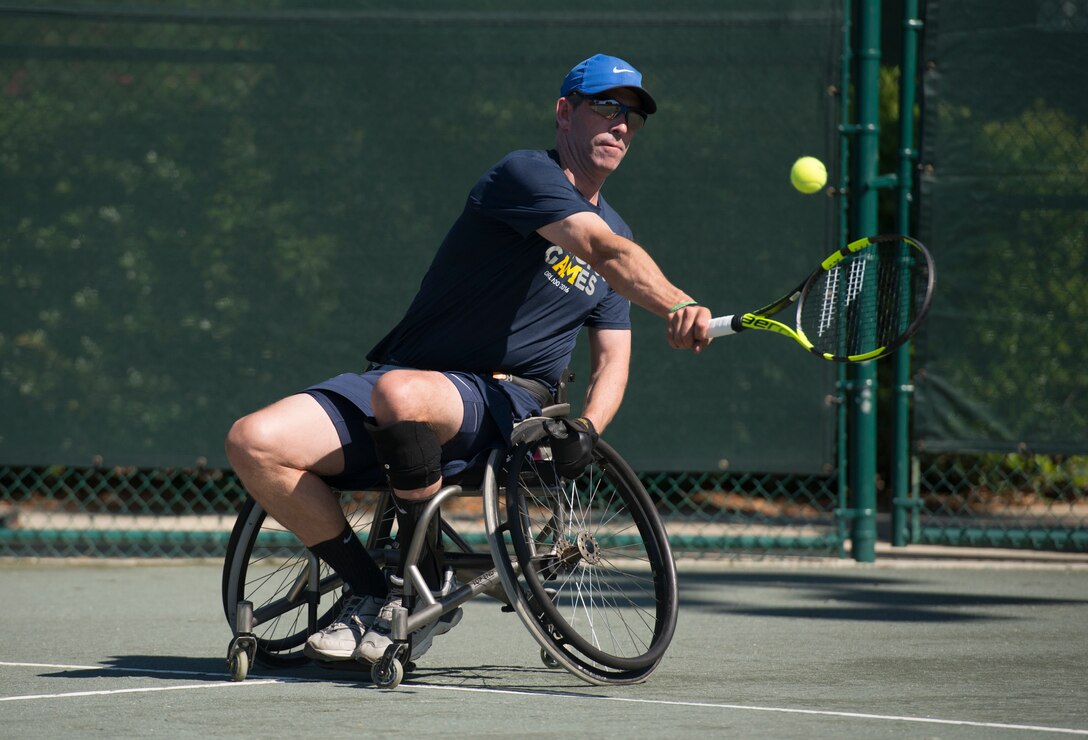 Retired Air Force Lt. Col. Dan Oosterhous returns a backhand volley shot while training in the wheelchair tennis event at the 2016 Invictus Games in Orlando, Fla., May 5, 2016. DoD photo by Roger Wollenberg