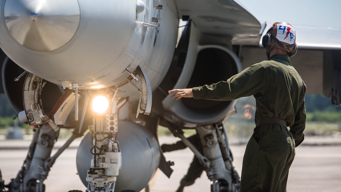 A maintainer stands in front of an F/A-18C Hornet on the flight line at Marine Corps Air Station Beaufort, South Carolina, May 4,2016. Marine Fighter Attack Squadron 251 is participating in a Weapons Systems Evaluation Program at Tyndall Air Force Base, Florida, May 6-20,2016. The program gives pilots experience with flying against real aircraft outside a simulation. The real world training helps Marines be tactically proficient and prepared to deploy.