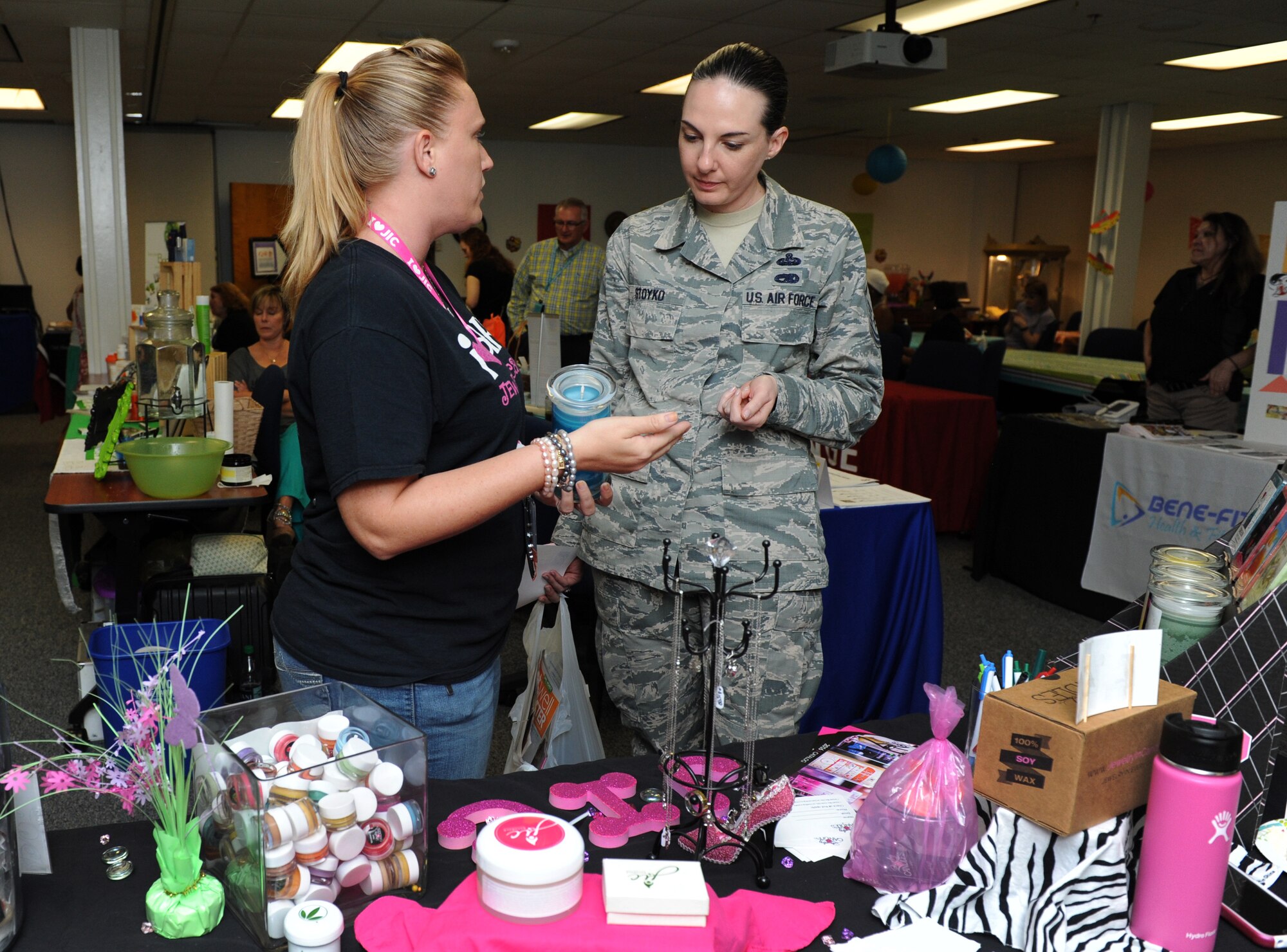 Mandi Pugh, a local jewelry business executive director, provides a product description to Master Sgt. Erika Stoyko, 81st Training Support Squadron training development support NCO in charge, during Pamper Me Day at the Sablich Center May 5, 2016, Keesler Air Force Base, Miss. Keesler’s Airman & Family Readiness Center has hosted the event for the past 12 years, offering spouses free manicures, hair styling tips and information and business booths. (U.S. Air Force photo by Kemberly Groue)
