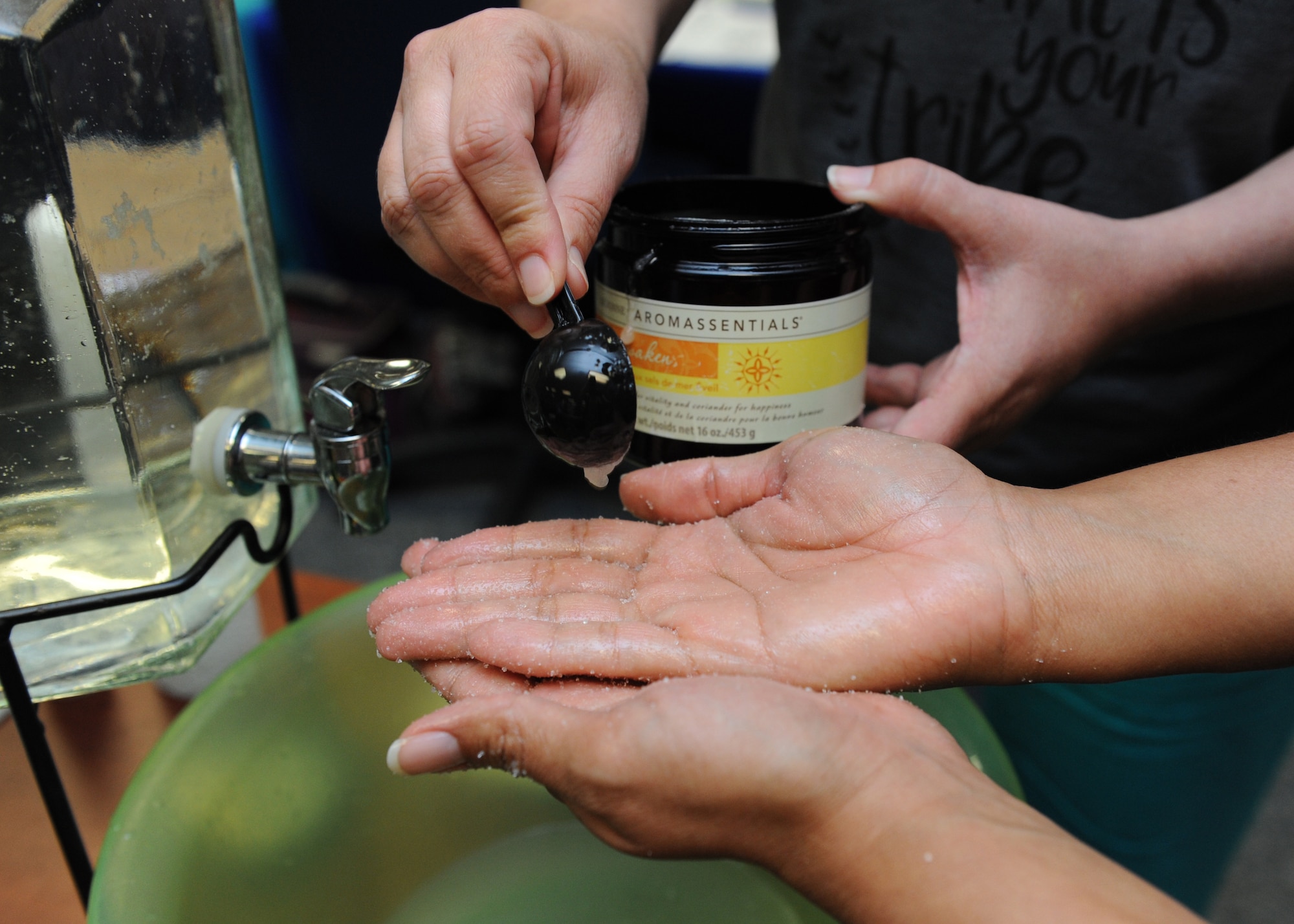 Sunnie Rae Zentner, spouse of Master Sgt. John Zentner, 81st Training Support Squadron transition flight chief, receives a scoop of sea salt scrub from Heather Brierton, local beauty product distributor, during Pamper Me Day at the Sablich Center May 5, 2016, Keesler Air Force Base, Miss. Keesler’s Airman & Family Readiness Center has hosted the event for the past 12 years, offering spouses free manicures, hair styling tips and information and business booths. (U.S. Air Force photo by Kemberly Groue)