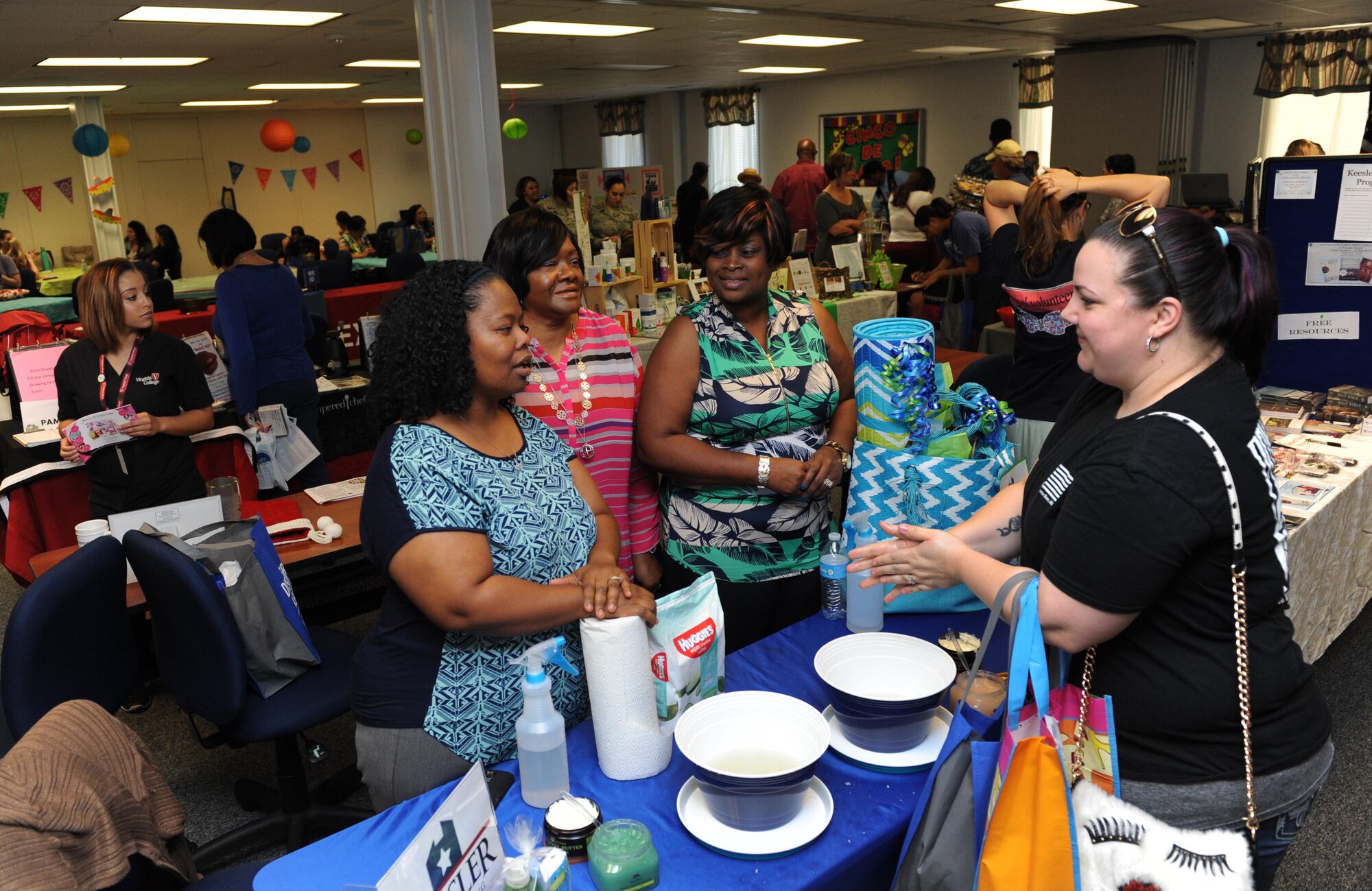 Rebecca Blanton, spouse of Staff Sgt. Micah Blanton, 81st Force Support Squadron manpower technician, receives information from Keesler Family Housing members during Pamper Me Day at the Sablich Center May 5, 2016, Keesler Air Force Base, Miss. Keesler’s Airman & Family Readiness Center has hosted the event for the past 12 years, offering spouses free manicures, hair styling tips and information and business booths. (U.S. Air Force photo by Kemberly Groue)